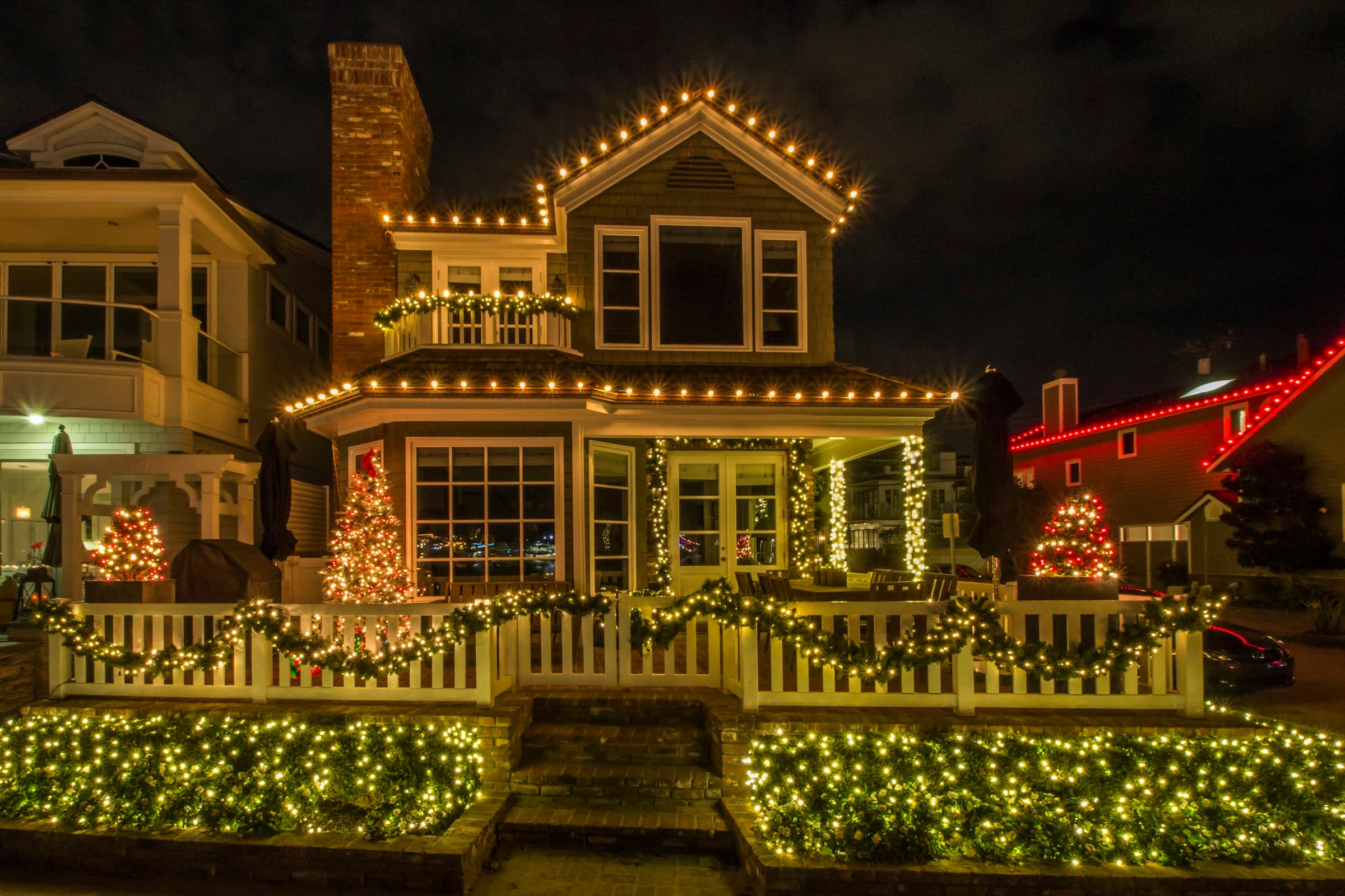 Home glowing with professionally installed Christmas lights at night